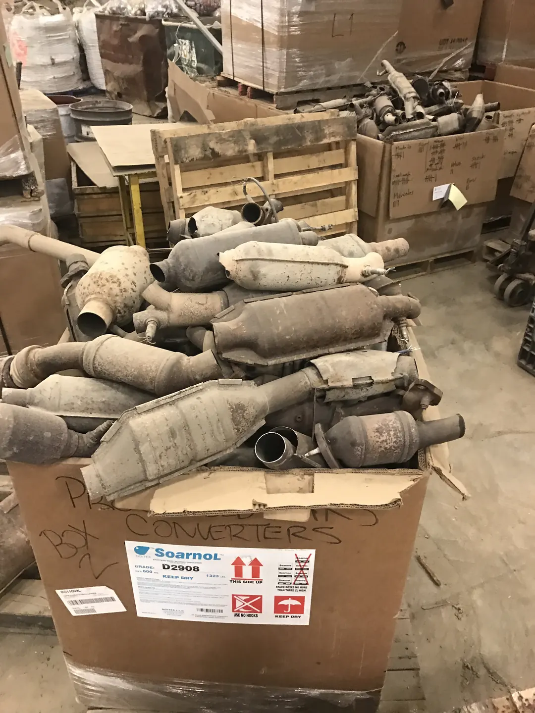 Boxes of used catalytic converters in a warehouse